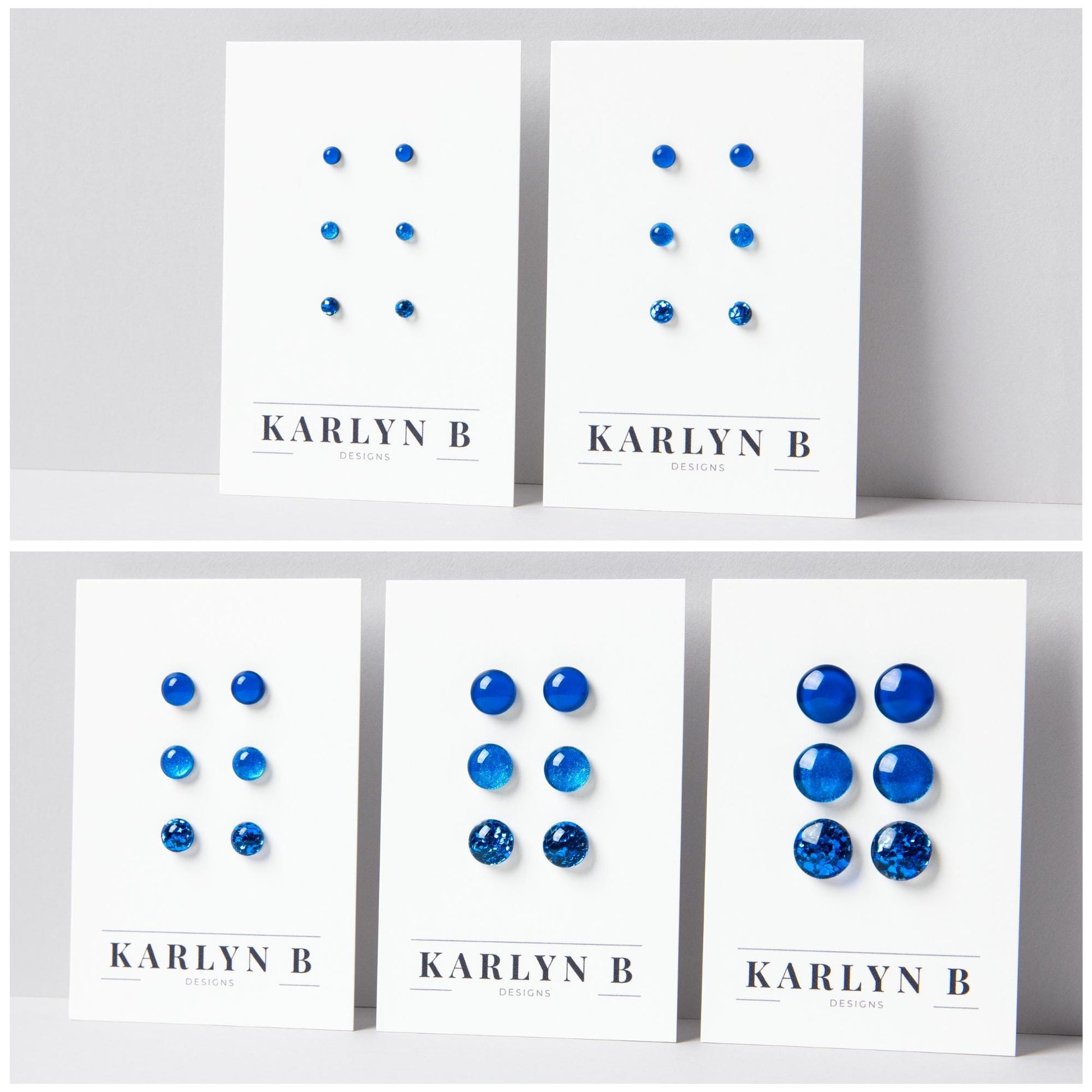 Five sets of stud earrings on white cards with the text "KARLYN B DESIGNS". Each set features three pairs of earrings in different shades of blue.
