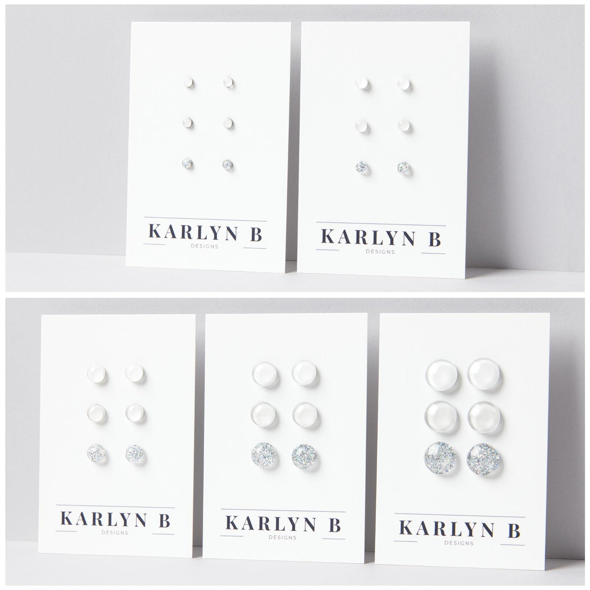 Five sets of stud earrings on white cards with the text "KARLYN B DESIGNS". Each set features three pairs of earrings in different shades of white.